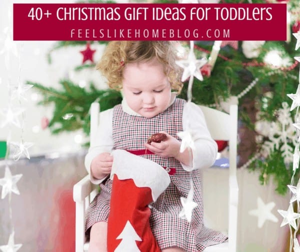 A toddler holding a Christmas gift